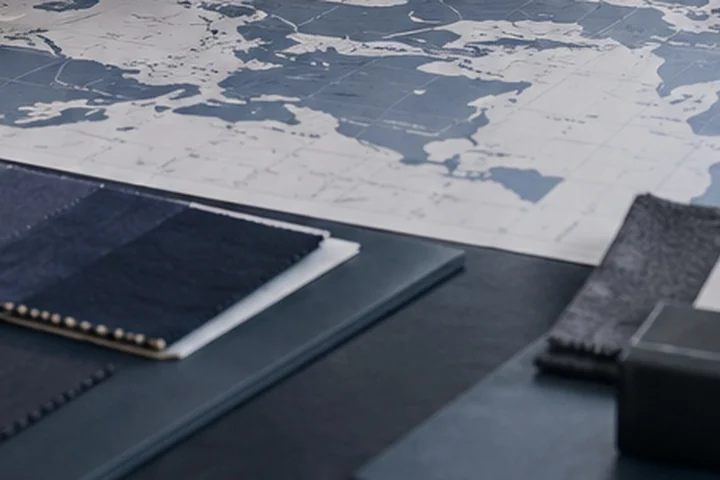 Maps, sourcing documents and material samples arranged on a strategy table